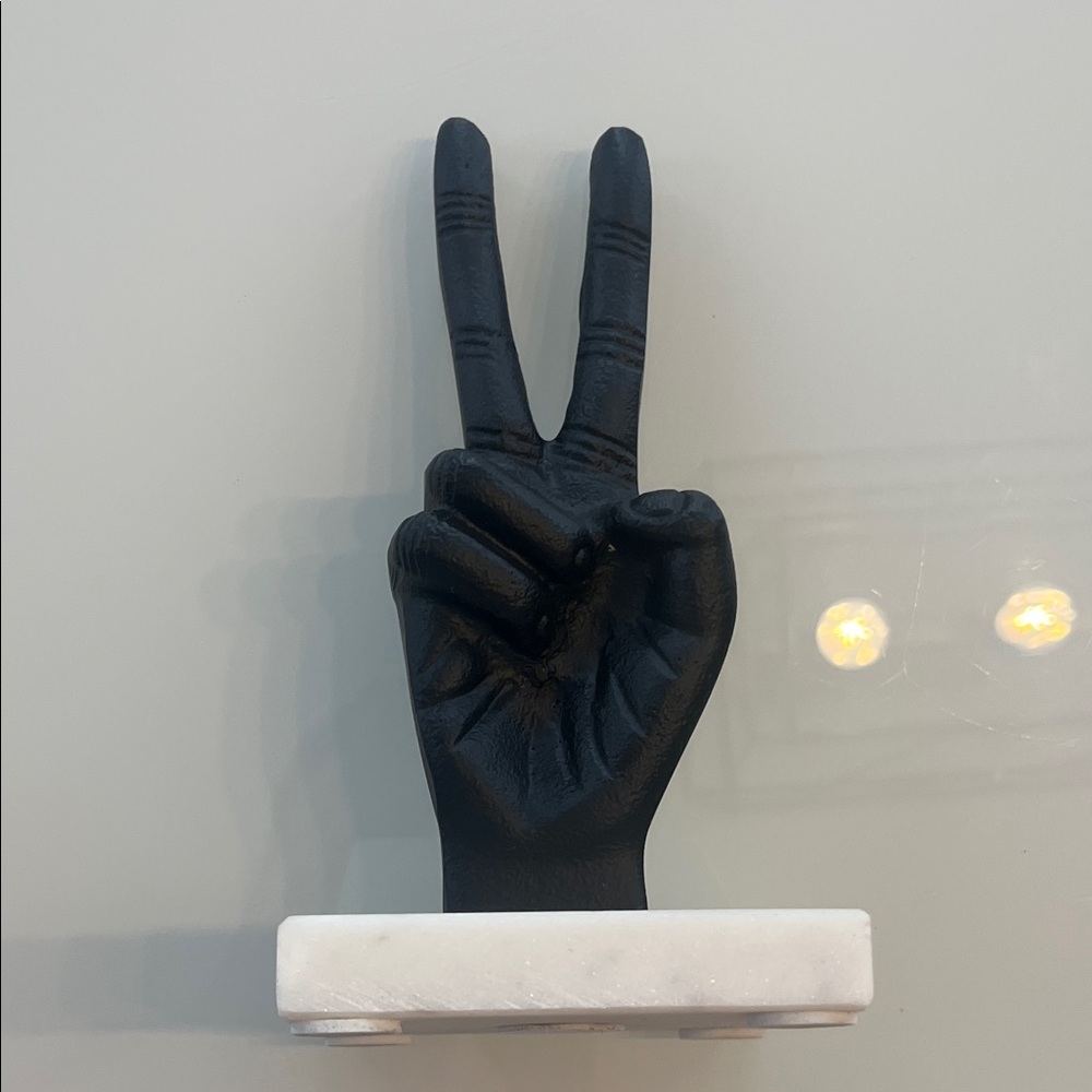 Black Peace Sign Hand Sculpture on White Base